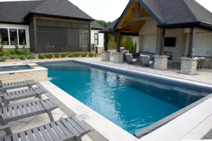 In ground pool with poolhouse and lounge chairs