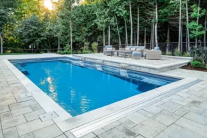 A luxury in ground pool with paver walkways surrounding