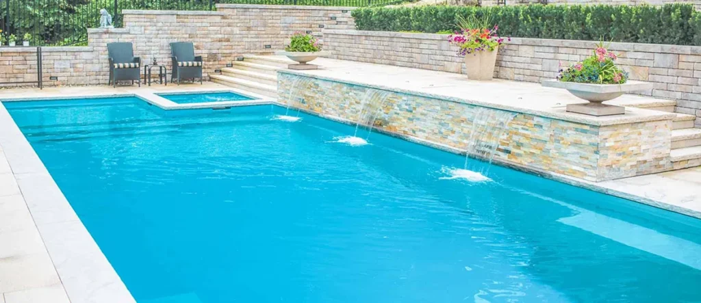 an in ground pool with three waterfalls flowing into the pool